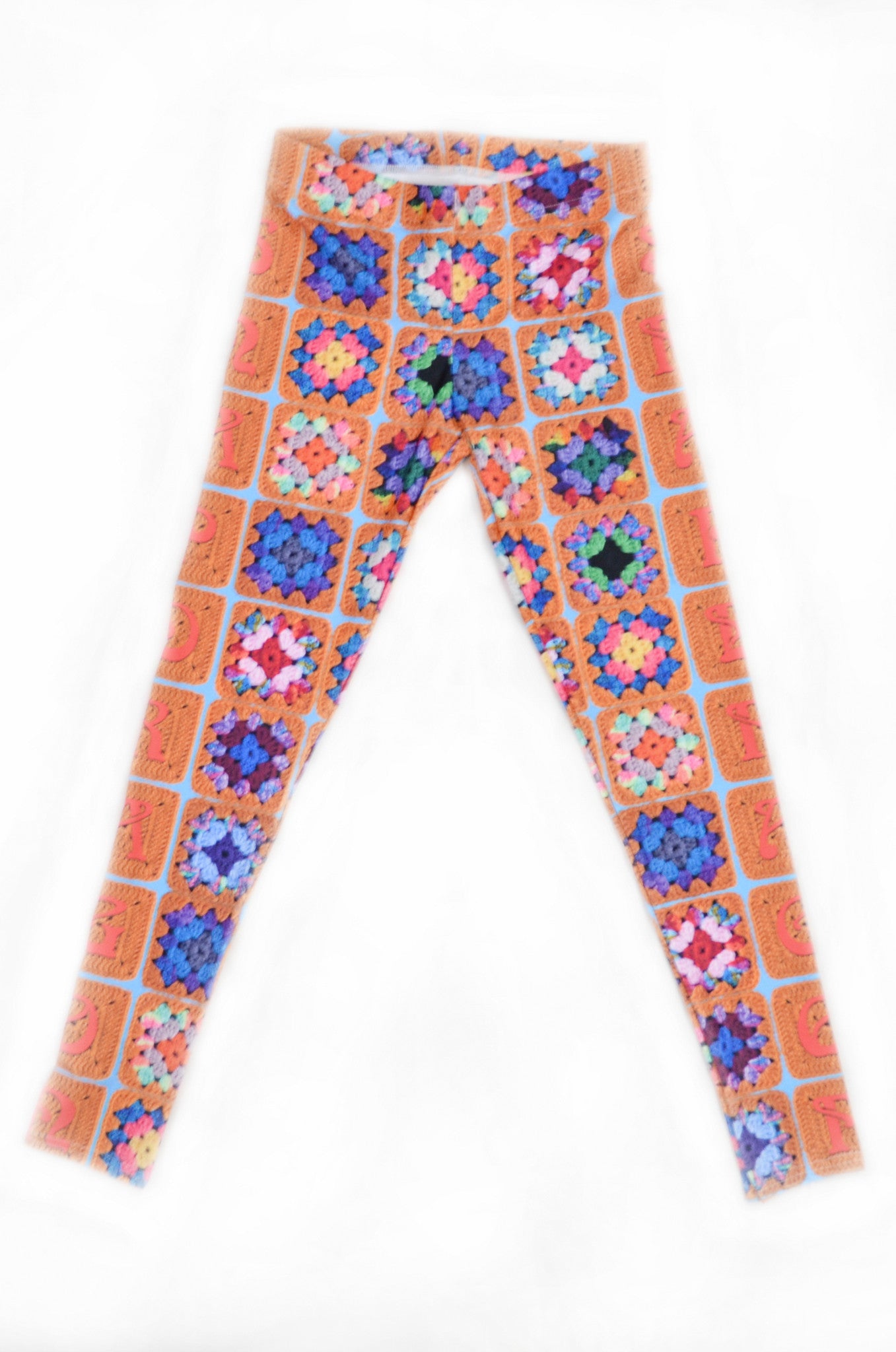 Snapdragon Brand Clothing Granny Square Crochet Print gold leggings in style Snappy features a 1970s vintage feel and a rainbow of colors. Made of comfortable spandex.