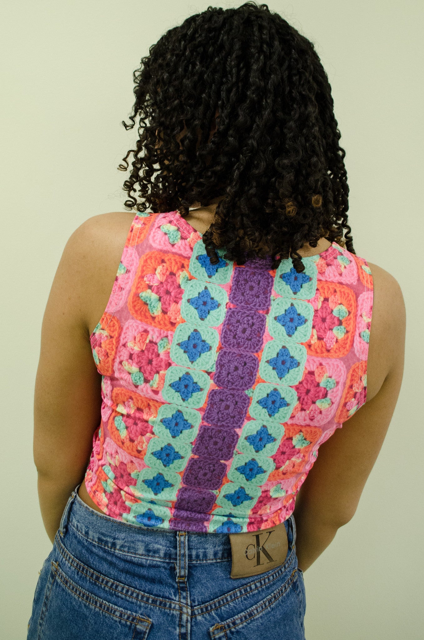 Snapdragon Brand Clothing Granny Square Crochet Print neon crop top cropped sleeveless shirt in style Playa Daisy features a vintage psychedelic boho feel and a rainbow of colors. Made of comfortable spandex. Daisies