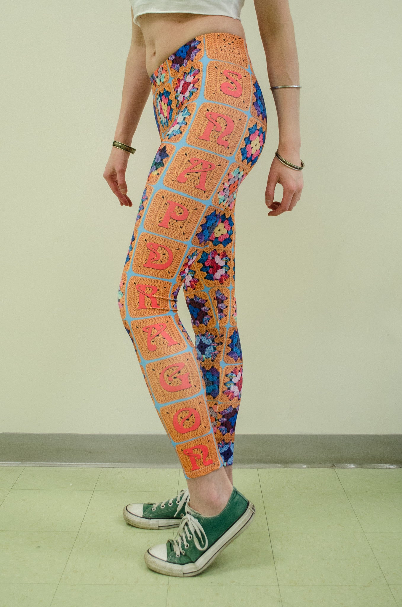 Snapdragon Brand Clothing Granny Square Crochet Print gold leggings in style Snappy features a 1970s vintage feel and a rainbow of colors. Made of comfortable spandex.