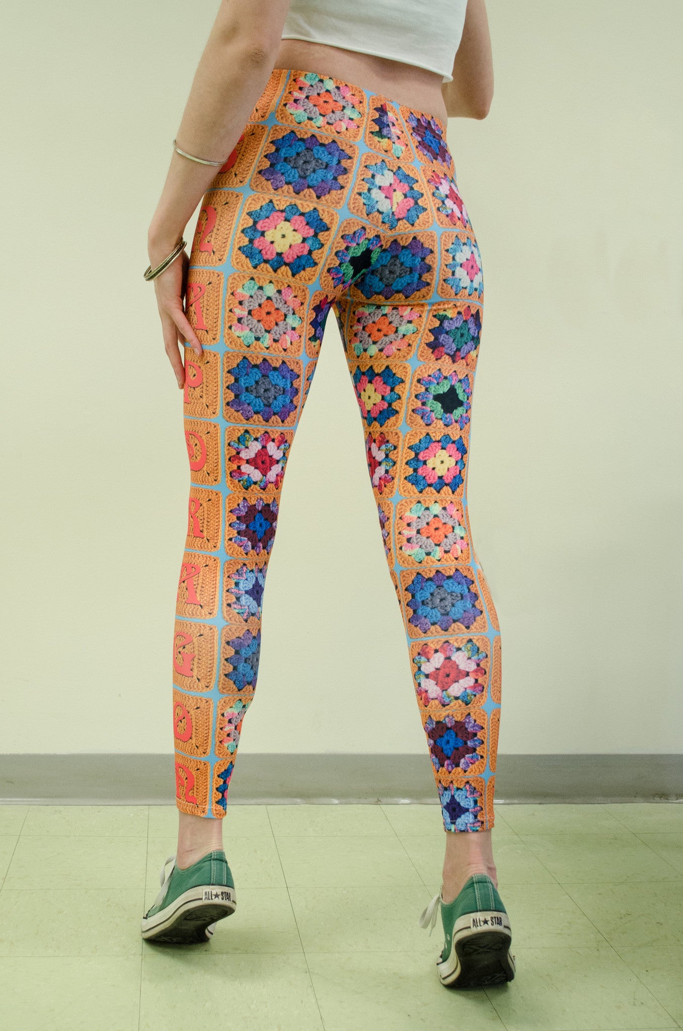 Snapdragon Brand Clothing Granny Square Crochet Print gold leggings in style Snappy features a 1970s vintage feel and a rainbow of colors. Made of comfortable spandex.