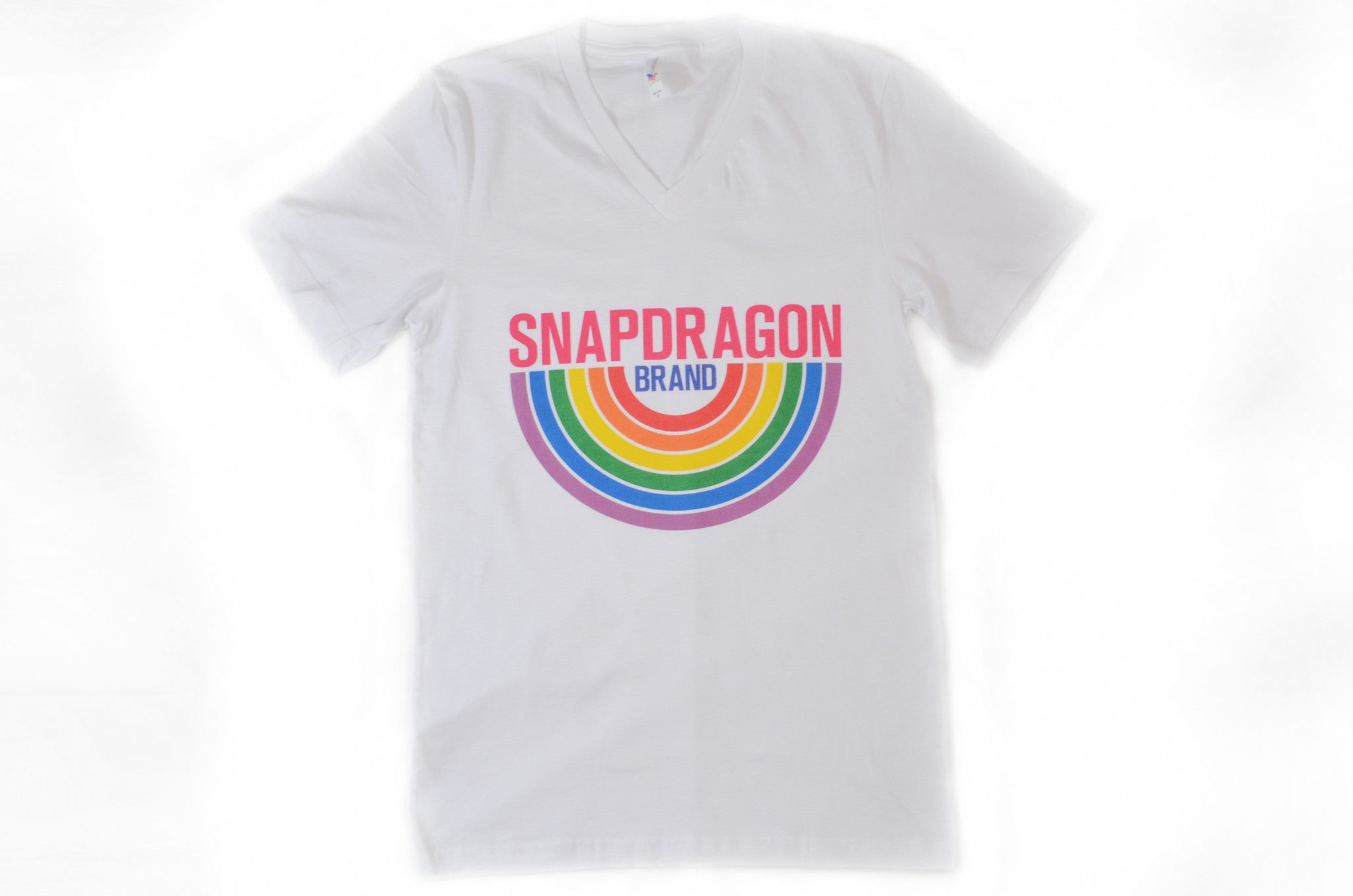 Snapdragon Brand Clothing Granny Square Crochet Print unisex rainbow v-neck tee t-shirt in style logo features a vintage psychedelic boho feel and a rainbow of colors. Made of comfortable cotton. lgbt lgbtq lgbtqi